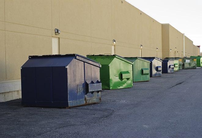 dumpsters lined up waiting to be filled with construction waste in Allston